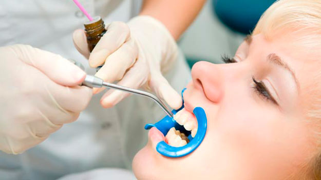Sealant being applied to a patient's teeth